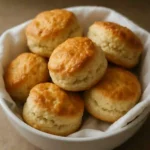 Golden gluten-free scones on wooden tray
