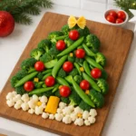 Overhead view of a completed veggie Christmas tree platter on a rustic wooden board in a bright